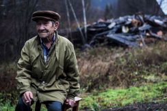 Resident by his burnt-out house in a demolished village in Kuzbass