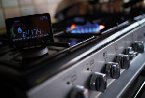 A handheld smart meter on a kitchen hob
