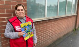 Big Issue North Vendor standing with magazine