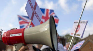 Photo of megaphone and flags at a UK anti-asylum seeker protest